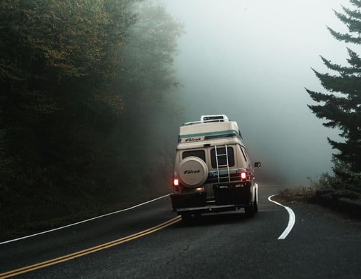 campervan-driving-down-misty-road