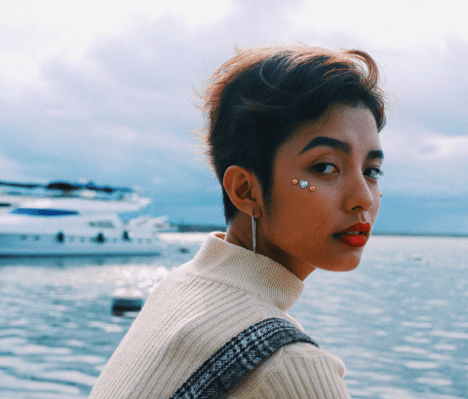 girl-in-front-of-ocean-looking-at-camera