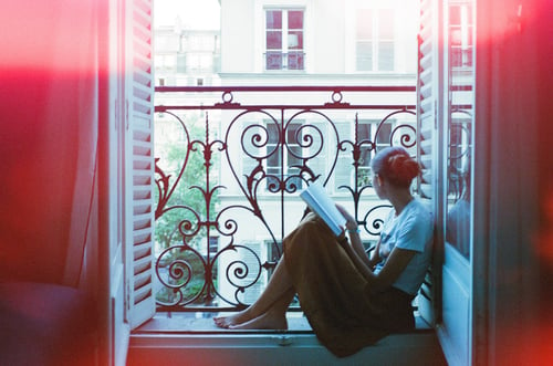 girl-reading-window-outside-urban