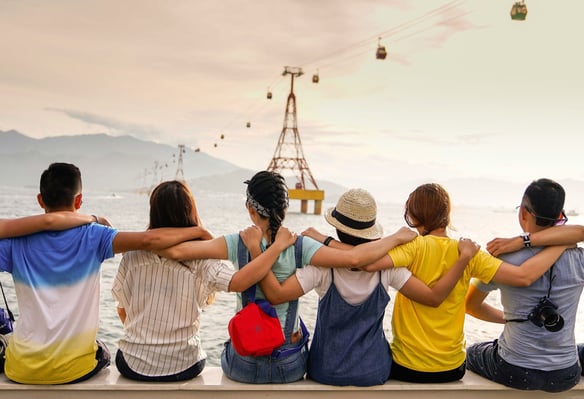 group-of-friends-facing-away-towards-water