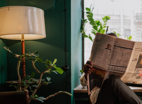 man-reading-newspaper-in-office-1